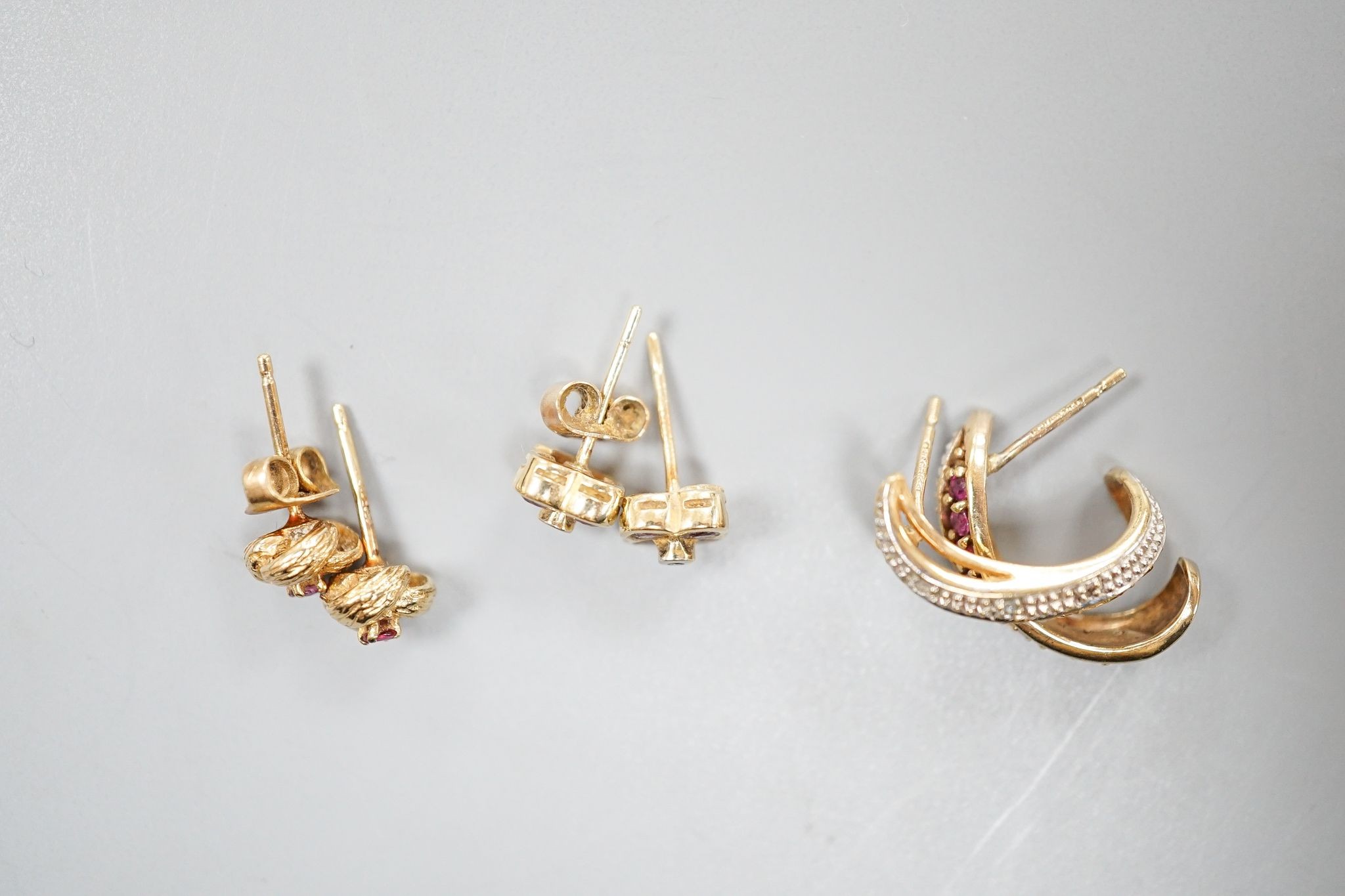 Three assorted modern pairs of 9ct and gem set ear studs